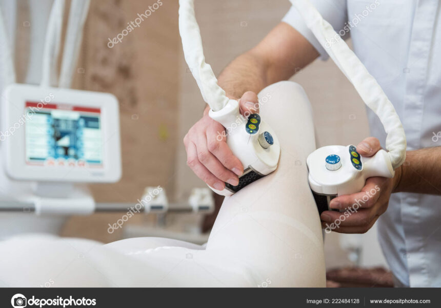 Procedure laser lipolysis of the woman hips in a beauty center.